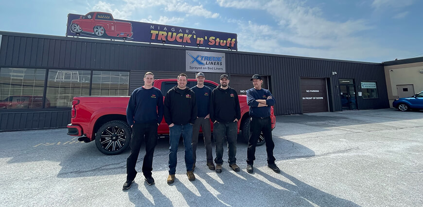 Truck 'n' Stuff Staff - Group shot of 5 Staff members standing in front of building
